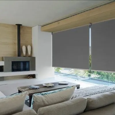 My sleek, grey roller blinds installed in a modern living room. They offer excellent light control and a minimalist aesthetic that complements contemporary furniture and open-plan layouts.