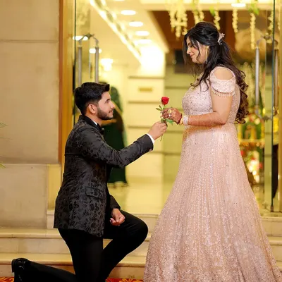 The classic proposal moment during an engagement ceremony. The groom on one knee with a rose is a timeless symbol of love that I love to capture.