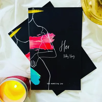 A photo of my debut poetry book, 'HER', a collection of words written for the feminine soul in all of us.