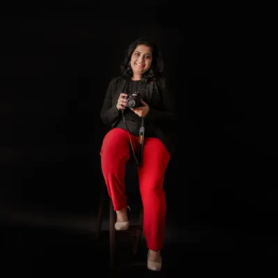 Hello, I'm Sneha! This is me in my happy place, camera in hand, ready to capture your family's precious moments. I pour my heart into every session and feel so lucky to do what I love.