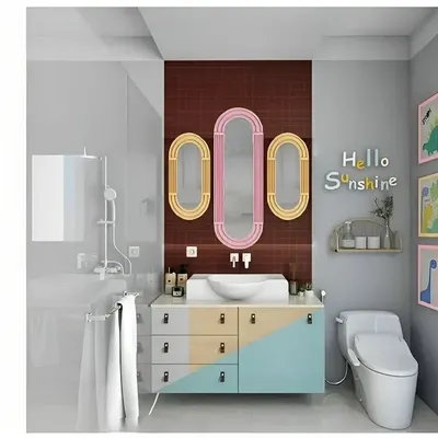 We also design fun and functional kids' bathrooms to complement their bedrooms. This design features playful pastel colors, unique oval mirrors, and a "Hello Sunshine" wall decal to create a cheerful and welcoming space.