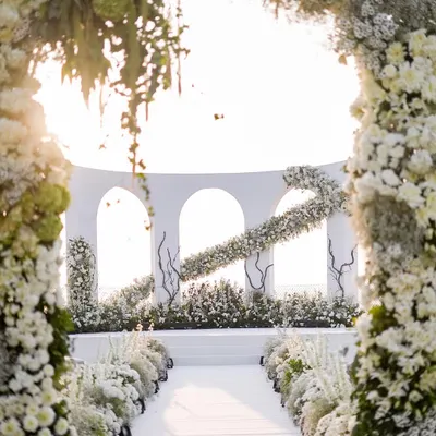 A stunning view down the aisle of an all-white wedding I designed in Goa. The floral archways frame the altar perfectly, creating a sense of heavenly grandeur for the ceremony.