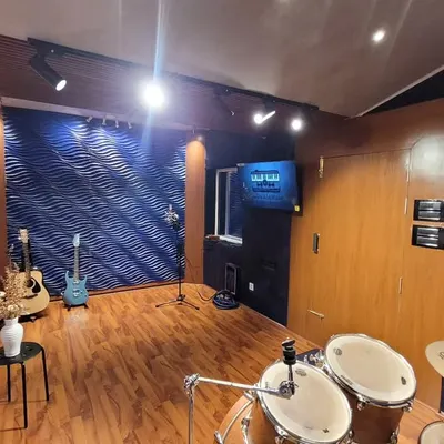 A wide view of our live room, showing the drum kit and vocal recording area. We designed it to be spacious and inspiring, a place where bands can comfortably jam and record together.