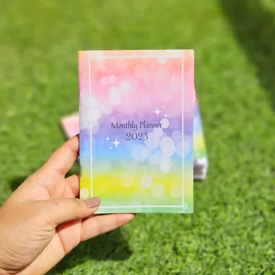 I designed this pocket sized 2023 monthly planner from scratch. The cover features a colorful bokeh design, and it's small enough to carry with you everywhere to stay organized on the go.
