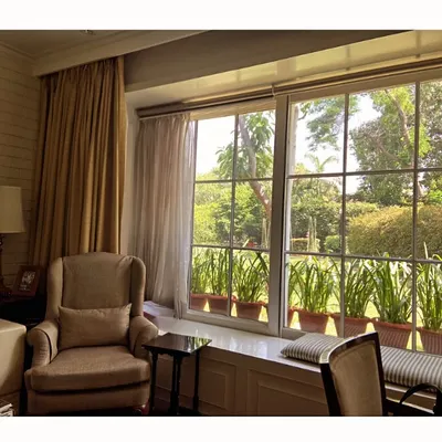 This serene sitting area is bathed in natural light from a large picture window. We designed a comfortable window seat to invite residents to pause and enjoy the view of the lush garden just outside.