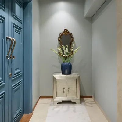 For the Bhanushali residence, I transformed the building's lift lobby into a personal foyer. By painting over existing panels and adding a refurbished console and vintage mirror from the client's previous home, I created a welcoming space that feels both new and familiar.
