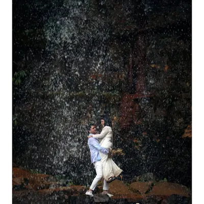 A moment of pure joy and abandon in front of a cascading waterfall. I love capturing these dynamic, high-energy shots that show a couple completely lost in the moment and in each other.