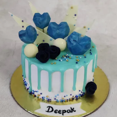 Feeling the blues in the best way possible! This drip cake is decorated with geometric chocolate hearts and sprinkles in various shades of blue.