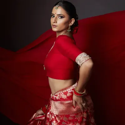 A powerful pose capturing the essence of our 'lal ishq' concept shoot. The makeup features a sharp, defined eye and glowing skin, designed to look stunning from every angle and under professional studio lighting.