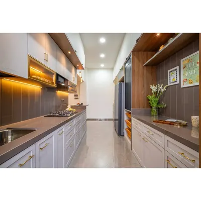 A sleek and modern parallel kitchen designed for ultimate functionality. The layout provides ample counter space and storage, with a sophisticated color palette of light grey, dark countertops, and warm wood accents.