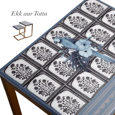 A close-up of the "Ek Aur Totta" C stack table. The design features a blue macaw set against a pattern of traditional floral motifs, blending my love for nature with heritage-inspired art.
