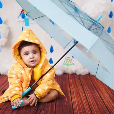 "Let the rain sing you a lullaby." Our monsoon mini-shoot is a fun way to celebrate the season, with a cute raincoat and umbrella.