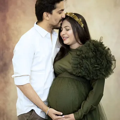 I love capturing the quiet connection between couples before their new journey begins. This tender moment, with a gentle forehead kiss, shows the love and anticipation that fills the air during a couple's maternity shoot.