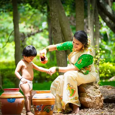 This outdoor portrait is from a 'naughty Krishna' themed shoot, a concept we designed to capture the playful spirit of childhood. We worked with the mother and son in a natural park setting, using thematic props like painted pots to create a truly unique and memorable image.