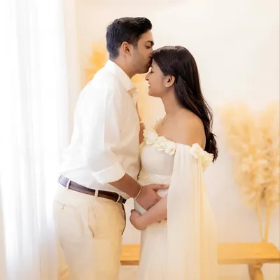 A gentle kiss and a quiet moment of anticipation. This is the kind of authentic emotion I aim to capture during a couple's maternity photoshoot.
