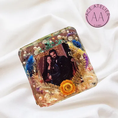 A beautiful deep-cast resin photo frame, filled with a variety of preserved flowers and botanicals. This freestanding block makes a wonderful personalized gift for any occasion.