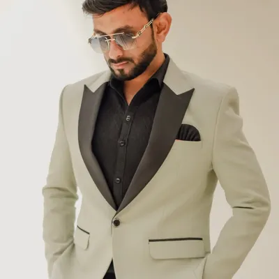 Sporting a stylish light green tuxedo with a black satin lapel. My wardrobe is carefully selected to match the sophistication of high-end events, from weddings to corporate galas.