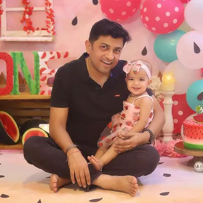 A precious father-daughter moment during the "One in a Melon" birthday shoot.