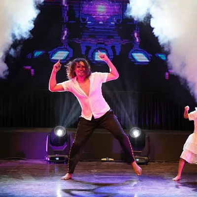 The stage comes alive with smoke and lights during our instructor's showstopping finale performance at Zest '25. This is the level of energy and professionalism we bring to every show.