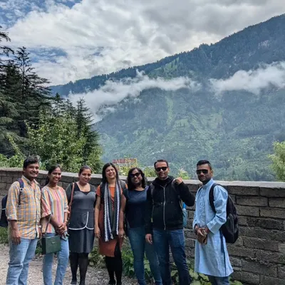 Our group on the first day of our Manali-Spiti adventure, with the cloud-covered Himalayan foothills in the background. This is the start of an unforgettable journey.