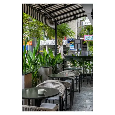 Outdoor seating is a quintessential part of the Bangalore experience. We designed this patio to feel like a natural extension of the cafe, framed by greenery to create a relaxed, refreshing vibe for lingering over coffee.