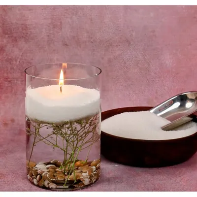 My soy wax pearls are candle-making made simple. Just pour them into any heat-safe container, like this glass vase with decorative stones, insert a wick, and light it up for an instant, beautiful candle.