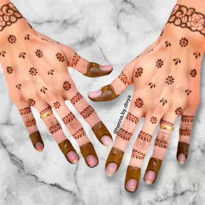 A perfect example of simple and elegant guest mehendi. This design features tiny floral booti patterns scattered across the palm with light leafy details on the fingers, offering a subtle and pretty look.