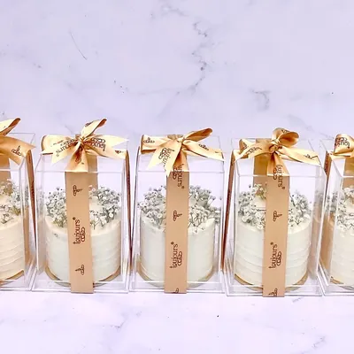 Elegant and delicious party favors. These mini cakes are individually boxed and decorated with delicate baby's breath, making them a perfect and sophisticated thank you gift for your guests.