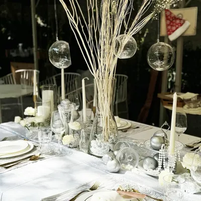 For our tablescape workshop, we created this ethereal winter wonderland theme. The setting features a clean white linen, silver accents, delicate glassware, and a centerpiece of white branches and glass baubles for a look of pure elegance.
