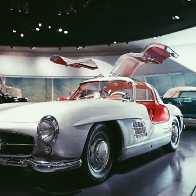 A classic Mercedes-Benz 300 SL Gullwing, a true icon of automotive history. I wanted to capture the elegance of its open doors and the vintage feel of the museum setting.