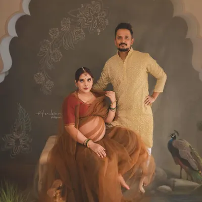 Celebrating the journey together. This painterly portrait features the couple in a setting inspired by Indian royalty, complete with a peacock and intricate architectural details. It shows how we can weave your shared story into a piece of fine art.