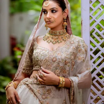 I love creating an intense yet dreamy look. For this bride, I designed a dramatic smokey eye and a flawless matte base to complement her ethereal white and gold lehenga, perfect for an evening reception.