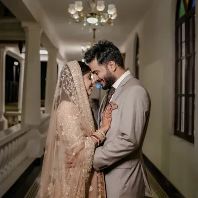 A tender, intimate moment between the couple during their Walima celebration, their smiles reflecting pure happiness.