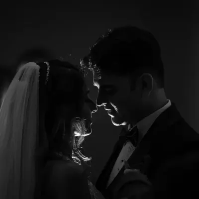 Using shadow and light to create a dramatic, intimate silhouette. This black and white portrait has a timeless, old-Hollywood feel, focusing purely on the couple's connection.