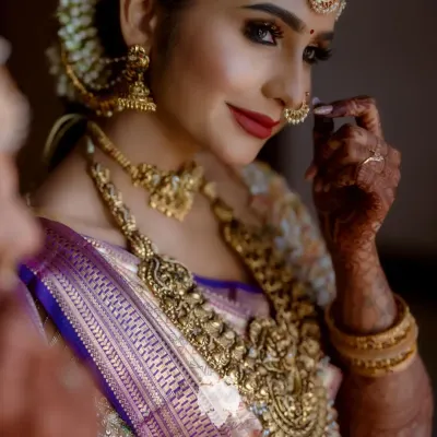 Heritage with a hint of now. Bride Priya in her luminous gold reception blouse, crafted in net and raw silk with embroidery that glows.
