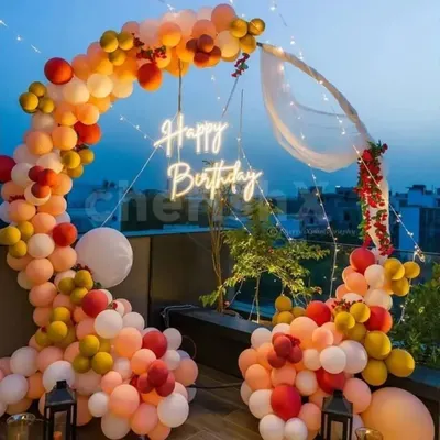 A duplicate image of the gorgeous sunset terrace party. The warm-toned balloon arch, neon sign, and city view create a perfect party atmosphere.