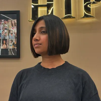 A chic and polished bob haircut with subtle highlights. This angle shows the clean lines of the cut and how the color adds just the right amount of dimension.