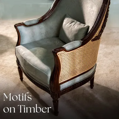 The Motifs on Timber collection celebrates heritage and meticulous craftsmanship. This armchair features intricate chip carving on a dark wood frame, balanced by soft, pastel velvet upholstery and classic caning for a unique design that transcends time.