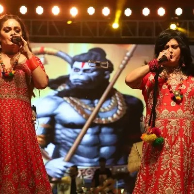 Singing a powerful devotional song with Hanuman ji displayed on the screen behind us. These moments bring a deep, spiritual energy to our performances.