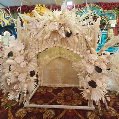 A stunning boho-themed mandap, intricately crafted from dried pampas grass, palm leaves, and other natural elements. This design offers a unique, rustic, and earthy charm for a one-of-a-kind Ganpati celebration.