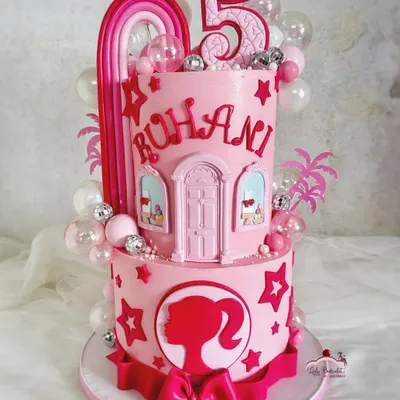 Come on Barbie, let's go party! This two-tier pink dream cake features a Barbie dreamhouse design, a silhouette, and fun disco ball details, perfect for a glamorous celebration.