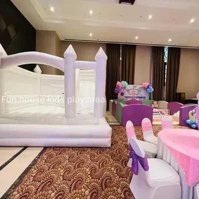 An indoor party setup featuring our elegant white bouncy castle alongside our pastel soft play area. This combination provides varied play options for children of different ages.