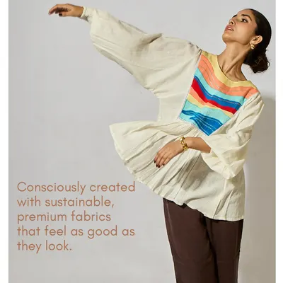Consciously created with sustainable, premium fabrics that feel as good as they look. This image of the Seascape Frill Top in motion captures the life and breath of my designs.