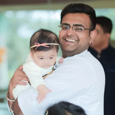 A candid shot of a smiling uncle holding the birthday girl. My event photography captures all the important guests who came to celebrate your little one's big day, ensuring no special moment is missed.