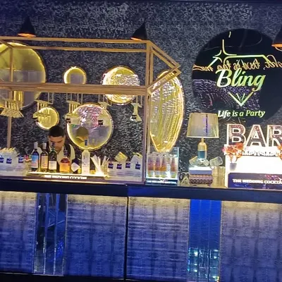 A full view of the 'Bling' themed bar, designed to be a party centerpiece. The setup includes a custom LED front, a gold-accented frame, and a neon sign.