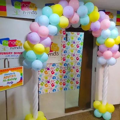 A simple yet beautiful pastel balloon arch to welcome guests to a 7th birthday party. An entrance decoration like this is a great way to set a festive mood from the moment your guests arrive.