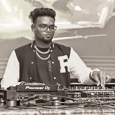 A black and white shot of me focused on the mixer. Every adjustment is about perfecting the sound for the dance floor.