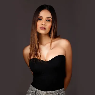 A classic headshot of a model with a direct and engaging gaze, set against a clean, solid grey background. This is the kind of professional and polished headshot I deliver for portfolios.