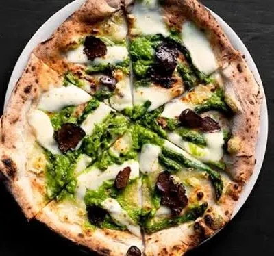Our Pizza Al Tartufo is a true showstopper. Made with a slow-fermented dough, it's topped with burrata, truffle oil, portobello ragout, and a hazelnut gremolata for the ultimate gourmet pizza experience.