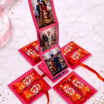A surprise that opens up with love. This handmade photo explosion box features a waterfall of your favorite pictures in the center, with KitKat chocolates hidden in every corner.